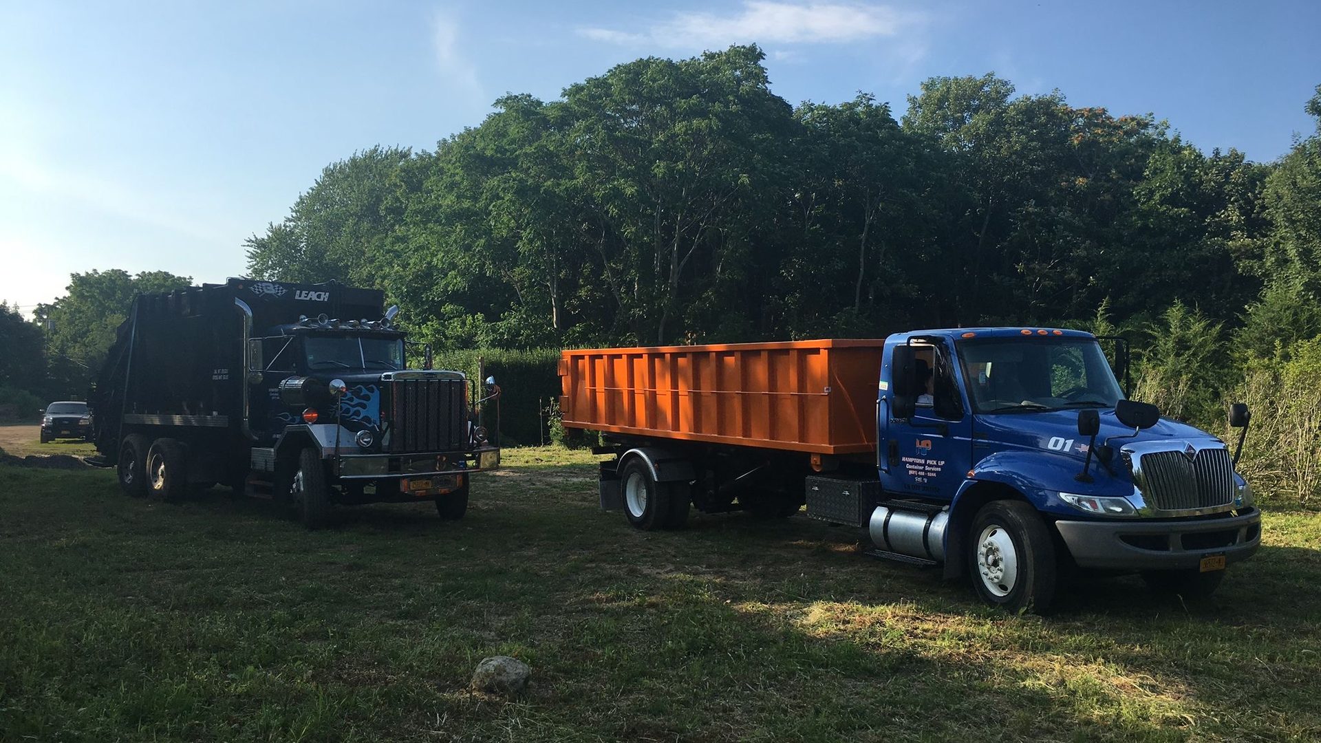 A Hamptons Pick Up roll-off dumpster truck on a job in Montauk, NY